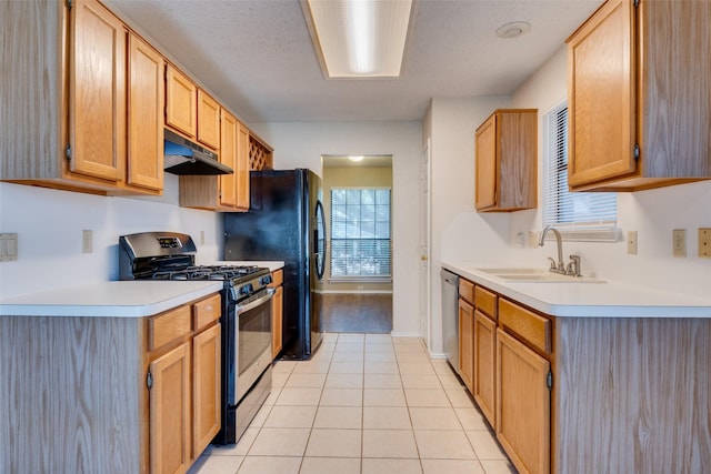 2009 Briargate Ln, Mesquite, TX 75181 - kitchen with stainless steel appliances, a sink, under cabinet range hood, light countertops, and light tile patterned flooring