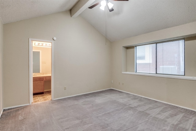 unfurnished bedroom with carpet flooring, ensuite bath, baseboards, ceiling fan, and a textured ceiling