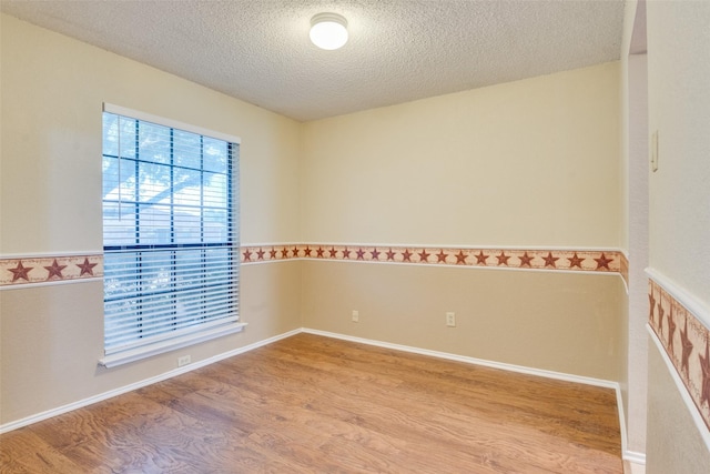 2009 Briargate Ln, Mesquite, TX 75181 - unfurnished room featuring wood finished floors and a textured ceiling