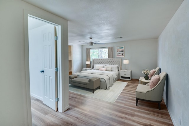 1104 Cortez St, Denison, TX 75020 - bedroom featuring light wood-style flooring, baseboards, ceiling fan, and a textured ceiling