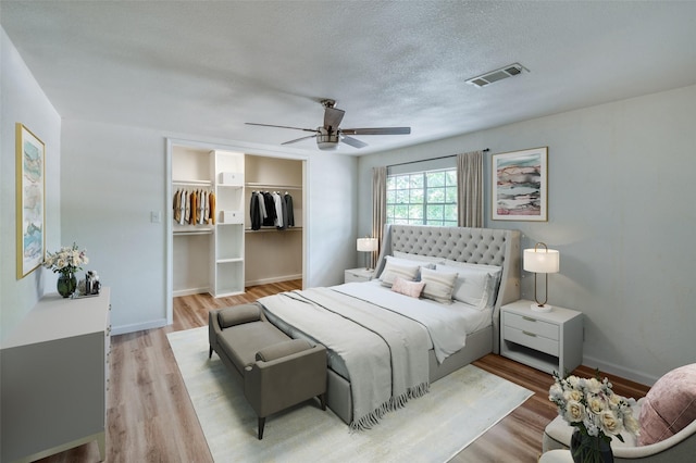 1104 Cortez St, Denison, TX 75020 - bedroom with wood finished floors, a ceiling fan, a spacious closet, a closet, and baseboards