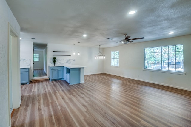 1104 Cortez St, Denison, TX 75020 - unfurnished living room with baseboards, light wood finished floors, recessed lighting, and a ceiling fan