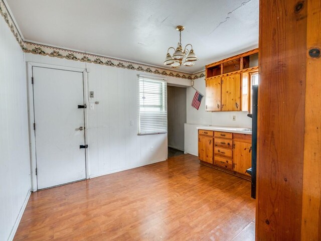 2203 Gould Ave, Fort Worth, TX 76164 - kitchen with a chandelier, brown cabinets, light wood finished floors, and light countertops