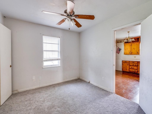 2203 Gould Ave, Fort Worth, TX 76164 - spare room with carpet flooring, ceiling fan, baseboards, and a chandelier