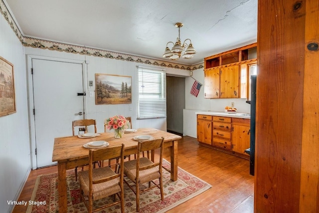 2203 Gould Ave, Fort Worth, TX 76164 - dining space with light wood-type flooring and a chandelier