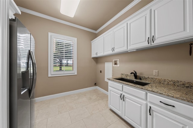 6021 Canyon Trl, Waco, TX 76657 - clothes washing area with cabinet space, ornamental molding, washer hookup, and baseboards