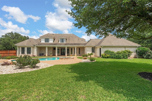6021 Canyon Trl, Waco, TX 76657 - back of house with a tiled roof, a pool with connected hot tub, and a patio