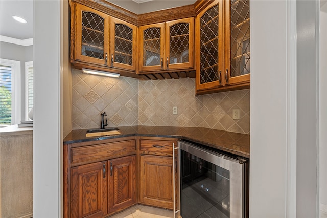 6021 Canyon Trl, Waco, TX 76657 - kitchen with wine cooler, glass insert cabinets, a sink, brown cabinetry, and backsplash