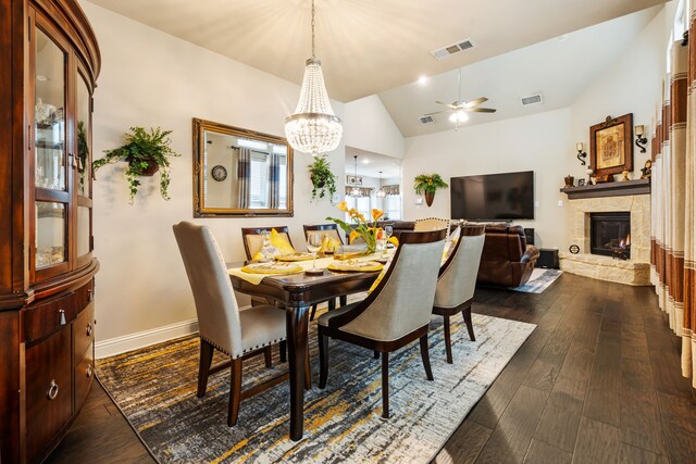 4302 Meadow Hawk Dr, Arlington, TX 76005 - dining space featuring ceiling fan, vaulted ceiling, a chandelier, a fireplace, and dark wood-style flooring