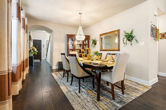 4302 Meadow Hawk Dr, Arlington, TX 76005 - dining space featuring arched walkways, baseboards, a chandelier, and dark wood finished floors