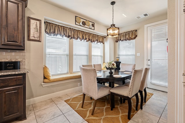 4302 Meadow Hawk Dr, Arlington, TX 76005 - dining space with light tile patterned floors, baseboards, and a chandelier