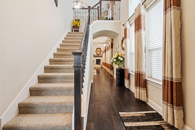 4302 Meadow Hawk Dr, Arlington, TX 76005 - stairway with arched walkways, wood-type flooring, baseboards, and a ceiling fan