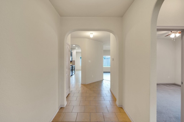 8213 White Hart Dr, Fort Worth, TX 76179 - corridor featuring arched walkways and light tile patterned flooring