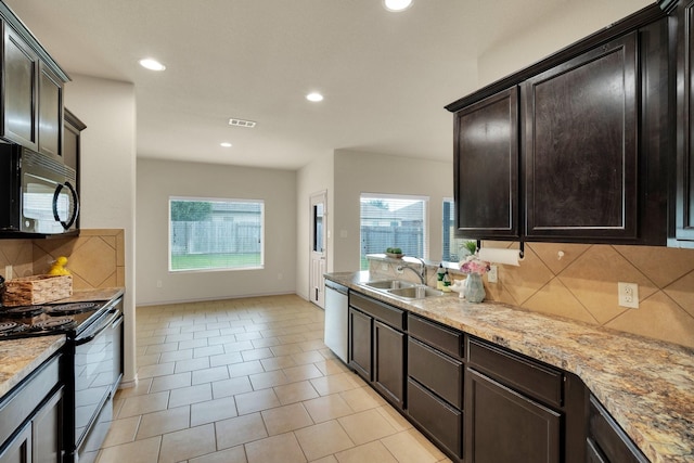 8213 White Hart Dr, Fort Worth, TX 76179 - kitchen with black appliances, plenty of natural light, backsplash, recessed lighting, and dark brown cabinets