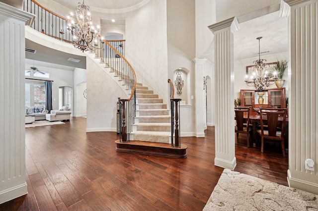 4651 Liam Dr, Frisco, TX 75034 - foyer featuring a chandelier, a towering ceiling, stairs, hardwood / wood-style flooring, and decorative columns