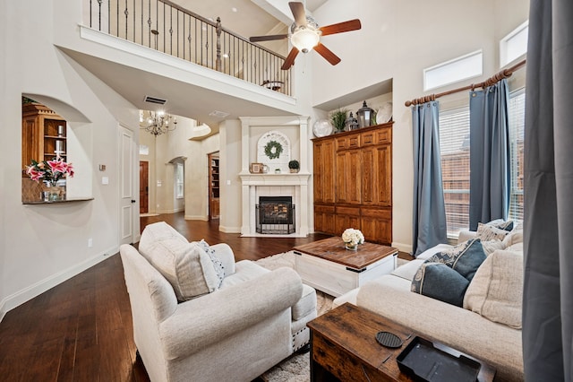 4651 Liam Dr, Frisco, TX 75034 - living area featuring a towering ceiling, a ceiling fan, a chandelier, dark wood-style floors, and baseboards