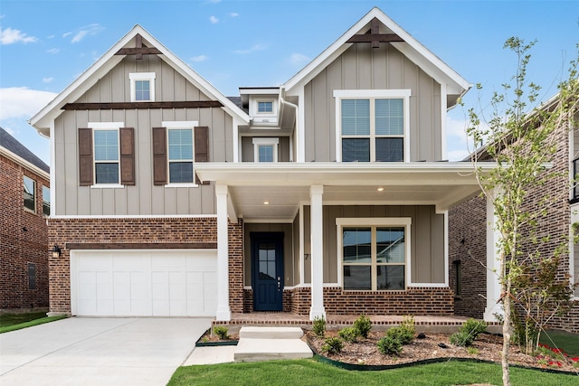 7113 El Matador Dr, Rowlett, TX 75088 - view of front of property featuring board and batten siding, brick siding, a porch, and driveway