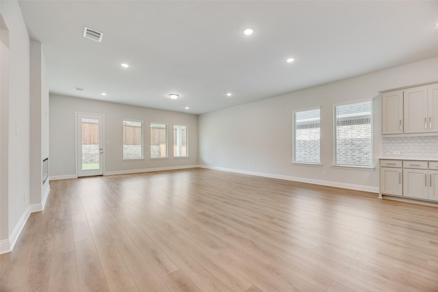 7113 El Matador Dr, Rowlett, TX 75088 - unfurnished living room featuring light wood-type flooring, baseboards, and recessed lighting