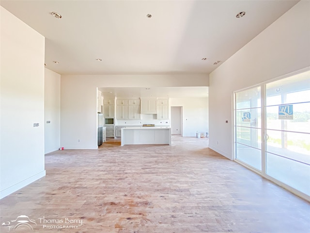 132 Pine Springs Cv, Tuscola, TX 79562 - unfurnished living room with light wood-type flooring and baseboards