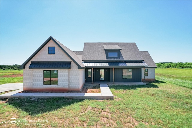 132 Pine Springs Cv, Tuscola, TX 79562 - rear view of house featuring brick siding, board and batten siding, a lawn, and a shingled roof