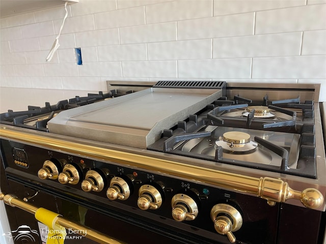 132 Pine Springs Cv, Tuscola, TX 79562 - kitchen view of black range with gas cooktop and decorative backsplash