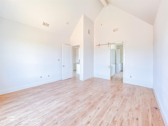 132 Pine Springs Cv, Tuscola, TX 79562 - spare room with high vaulted ceiling, light wood-type flooring, beam ceiling, and baseboards
