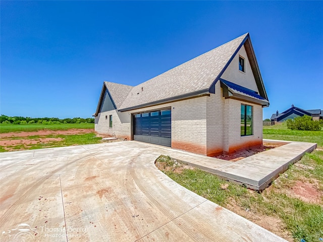 132 Pine Springs Cv, Tuscola, TX 79562 - view of property exterior with brick siding, concrete driveway, a shingled roof, and an attached garage