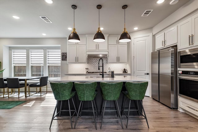1806 Clouded Wren Dr, Arlington, TX 76005 - kitchen with stainless steel appliances, an island with sink, light countertops, recessed lighting, and tasteful backsplash