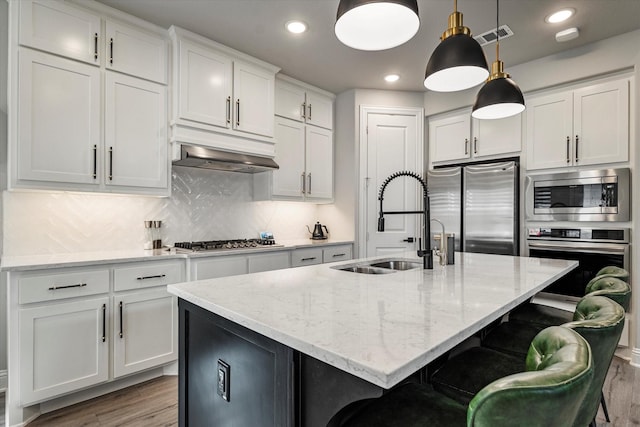 1806 Clouded Wren Dr, Arlington, TX 76005 - kitchen with stainless steel appliances, a sink, wood finished floors, white cabinets, and recessed lighting