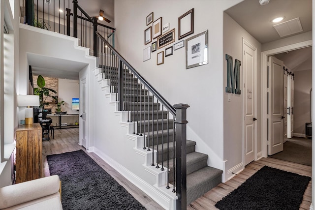 1806 Clouded Wren Dr, Arlington, TX 76005 - stairs featuring wood finished floors, baseboards, recessed lighting, and a high ceiling