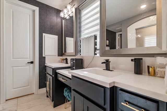 1806 Clouded Wren Dr, Arlington, TX 76005 - bathroom with marble look tile flooring, two vanities, and baseboards