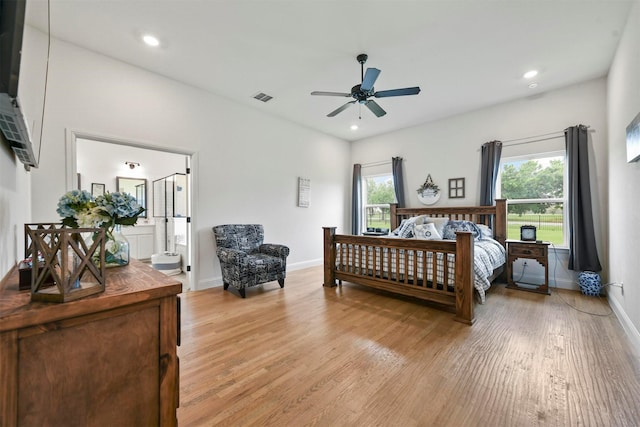 1511 Horseshoe Ct, Justin, TX 76247 - bedroom with light wood-style flooring, multiple windows, baseboards, recessed lighting, and connected bathroom