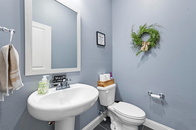1511 Horseshoe Ct, Justin, TX 76247 - half bath with toilet, baseboards, tile patterned flooring, and a sink