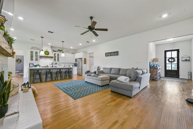1511 Horseshoe Ct, Justin, TX 76247 - living area with ceiling fan, light wood-style floors, recessed lighting, and a fireplace