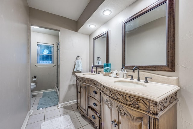 1507 Greenbrier Dr, Sherman, TX 75092 - bathroom with toilet, double vanity, a stall shower, tile patterned floors, and baseboards