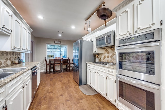 1507 Greenbrier Dr, Sherman, TX 75092 - kitchen with stainless steel appliances, white cabinets, tasteful backsplash, and recessed lighting