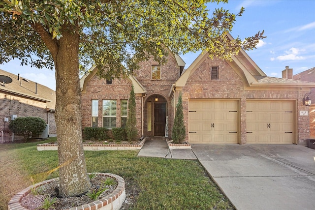 615 Louder Way, Fate, TX 75087 - traditional home with driveway, brick siding, a garage, and a front lawn