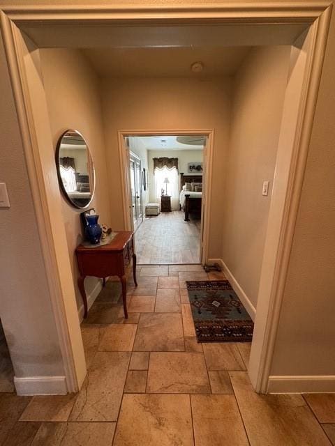 255 Chaparrals Run, Azle, TX 76020 - corridor with stone tile flooring and baseboards