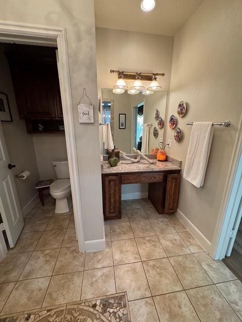 255 Chaparrals Run, Azle, TX 76020 - bathroom featuring tile patterned flooring, baseboards, toilet, and vanity