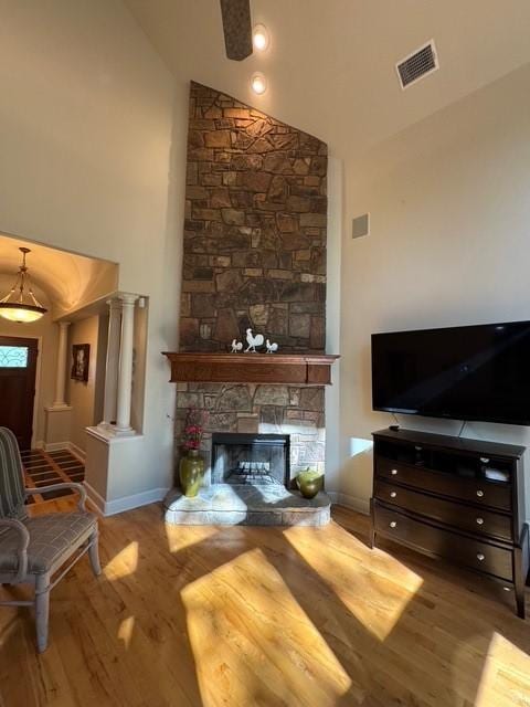 255 Chaparrals Run, Azle, TX 76020 - living area with high vaulted ceiling, wood finished floors, baseboards, and a stone fireplace