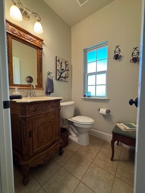 255 Chaparrals Run, Azle, TX 76020 - bathroom with tile patterned floors, toilet, vanity, and baseboards