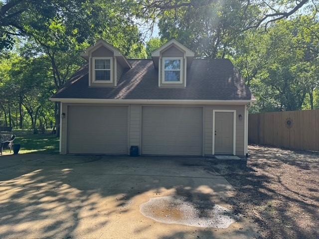 255 Chaparrals Run, Azle, TX 76020 - detached garage with fence and view of scattered trees