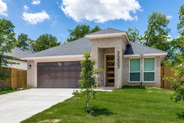 3235 Pine St, Dallas, TX 75215 - view of front facade with brick siding, an attached garage, driveway, and roof with shingles