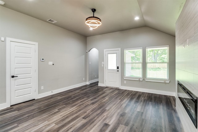 3235 Pine St, Dallas, TX 75215 - entryway with dark wood-style flooring, lofted ceiling, arched walkways, and baseboards