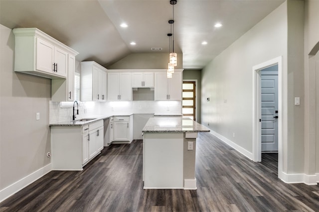 3235 Pine St, Dallas, TX 75215 - kitchen with dark wood-style floors, decorative backsplash, light stone counters, vaulted ceiling, and recessed lighting