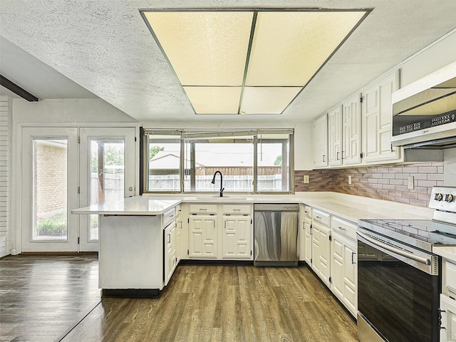 5632 Twitty St, The Colony, TX 75056 - kitchen featuring stainless steel appliances, a sink, light countertops, dark wood finished floors, and white cabinets