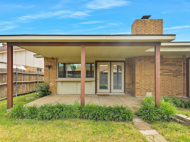 5632 Twitty St, The Colony, TX 75056 - back of property with brick siding, a chimney, and a patio area
