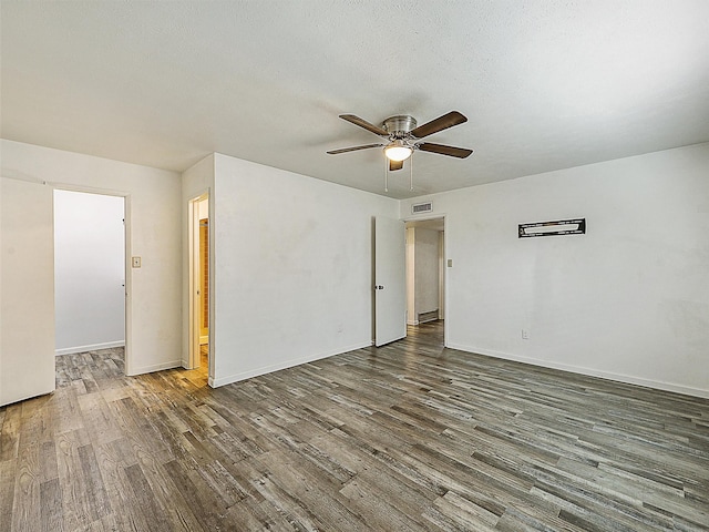 5632 Twitty St, The Colony, TX 75056 - spare room with wood finished floors, ceiling fan, and baseboards