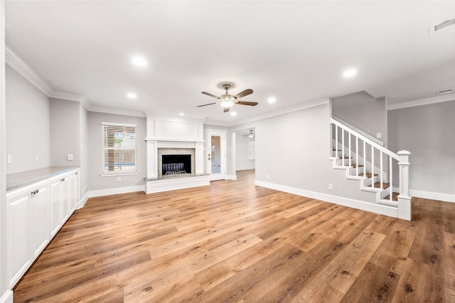 9916 Sandalwood Dr, Woodway, TX 76712 - unfurnished living room featuring recessed lighting, light wood-type flooring, crown molding, ceiling fan, and stairs