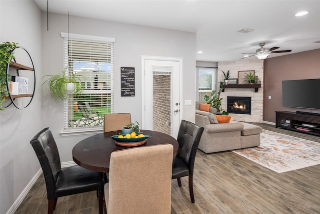 1619 Temperance Way, Wylie, TX 75098 - dining space featuring wood finished floors, ceiling fan, baseboards, a fireplace, and recessed lighting
